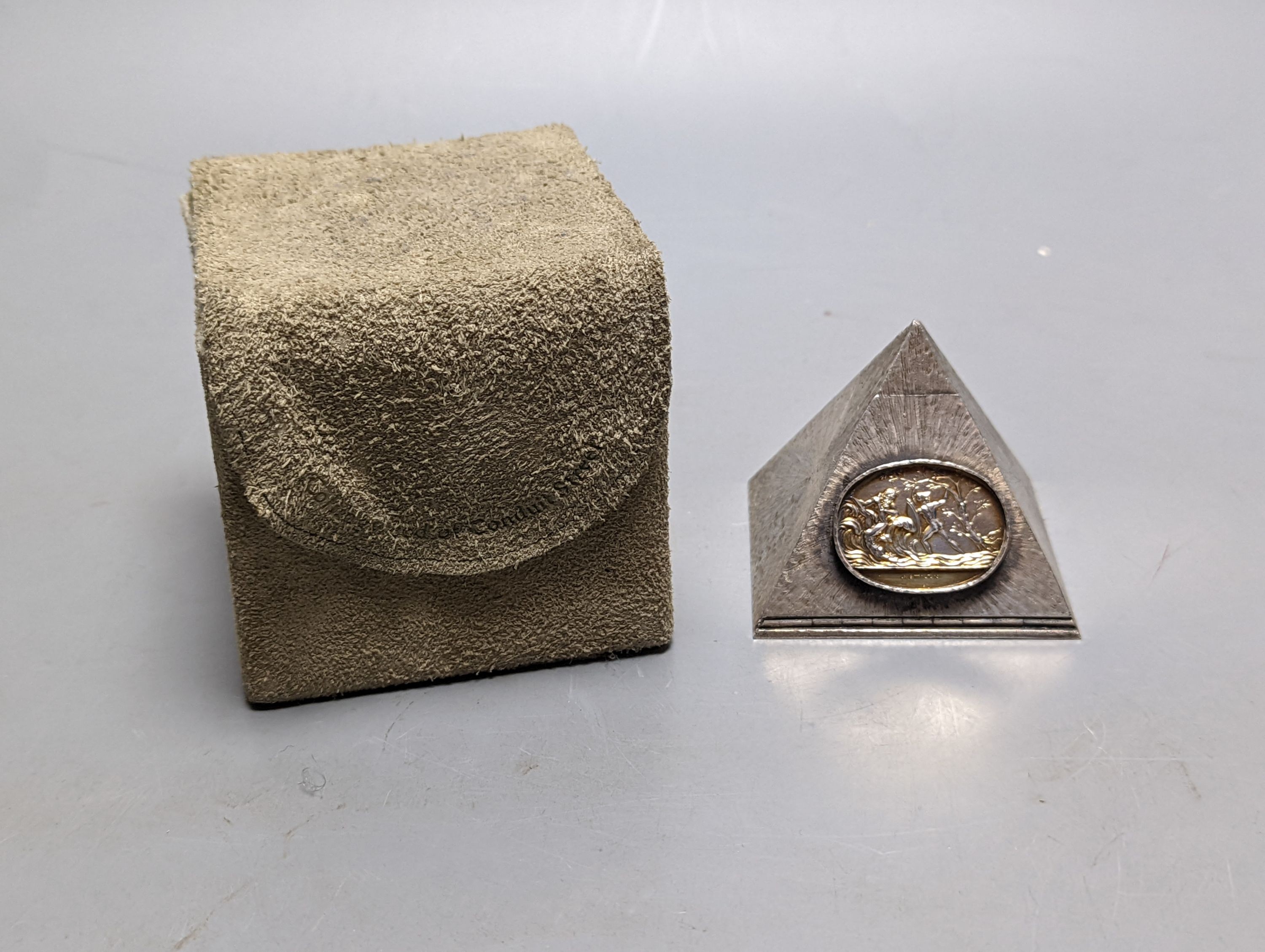 A boxed Collingwood of Conduit Street white metal pyramid shaped box, containing five dice and with applied oval plaque, height 61mm.